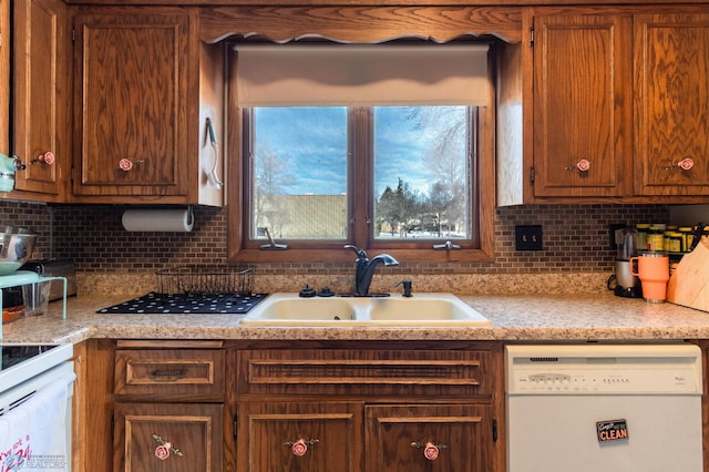 kitchen featuring sink, white appliances, and decorative backsplash