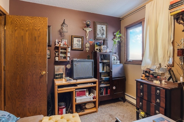 bedroom with light carpet, a baseboard heating unit, and a textured ceiling