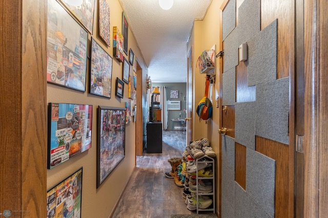 corridor with dark wood-type flooring and a textured ceiling