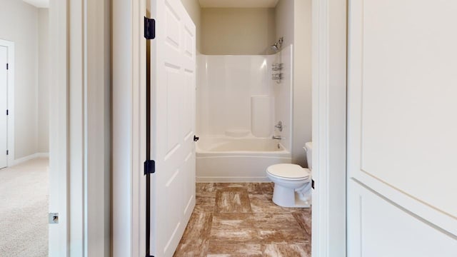 bathroom featuring shower / bathtub combination and toilet