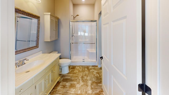 bathroom with vanity, toilet, and walk in shower