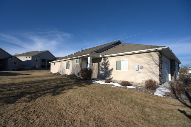 rear view of property with a lawn