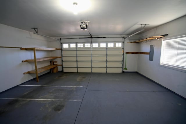garage featuring electric panel and a garage door opener