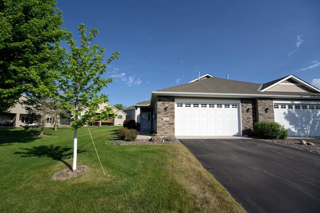 6150 Boulder Ridge Dr, Rockford, MN 55373 - single story home with asphalt driveway, an attached garage, a front yard, stone siding, and a shingled roof