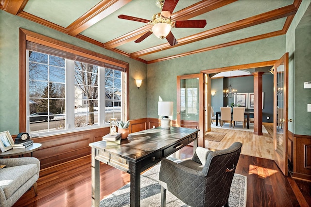 office space featuring light wood-style floors, a healthy amount of sunlight, a wainscoted wall, and ornate columns