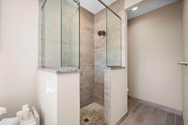 full bath featuring baseboards and walk in shower