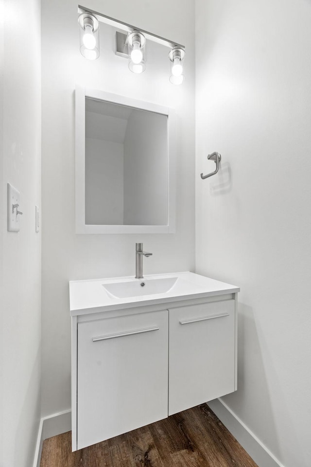 bathroom featuring hardwood / wood-style flooring and vanity