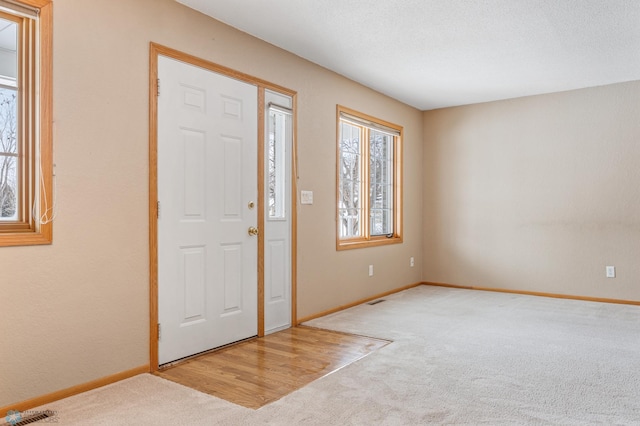 foyer entrance with carpet floors