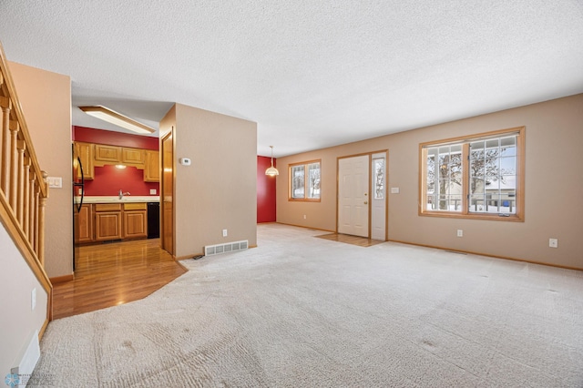 living room with vaulted ceiling, light colored carpet, and a textured ceiling