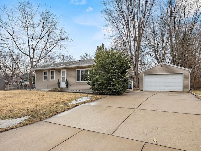 single story home with an outdoor structure, fence, and a detached garage