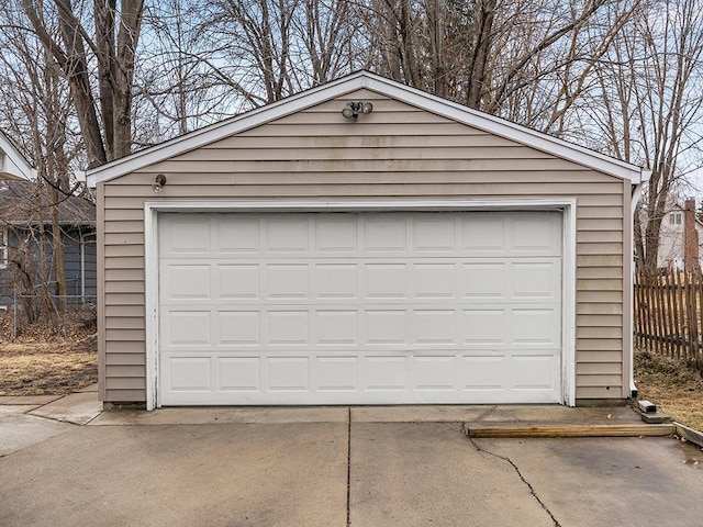 detached garage featuring fence