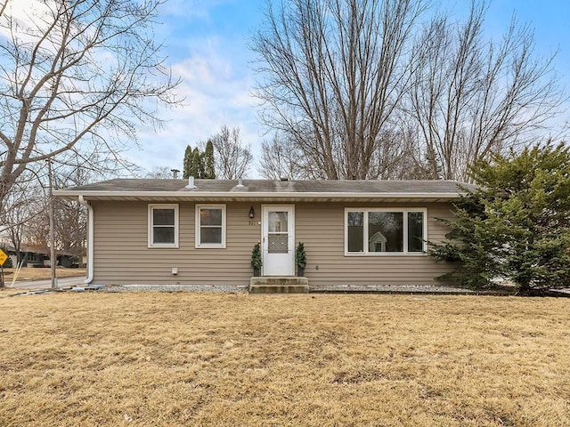 ranch-style house with entry steps and a front lawn