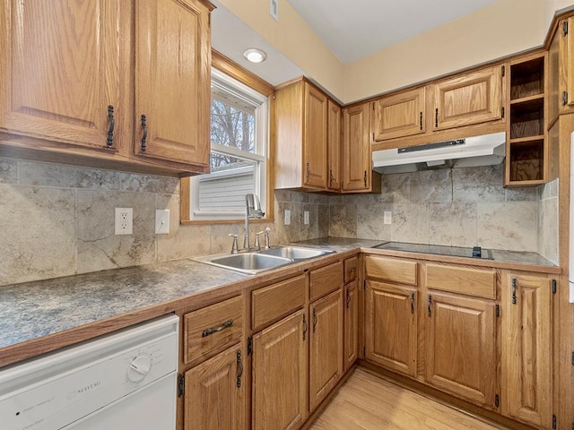 kitchen with white dishwasher, black electric cooktop, light wood-style flooring, under cabinet range hood, and a sink