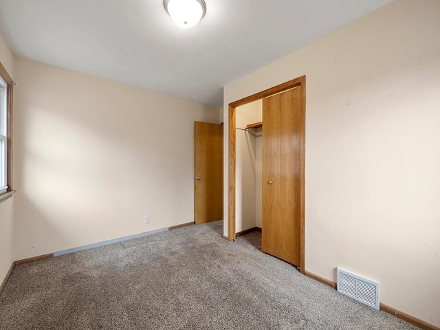 unfurnished bedroom featuring light carpet, baseboards, and visible vents