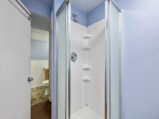 full bath with vanity, wainscoting, a shower stall, and toilet