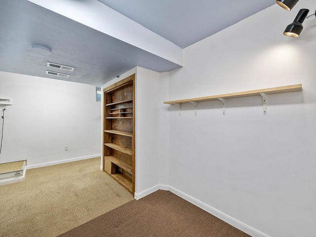 finished basement featuring carpet flooring, visible vents, and baseboards