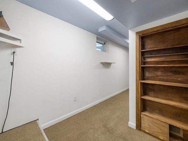 below grade area featuring carpet floors and baseboards