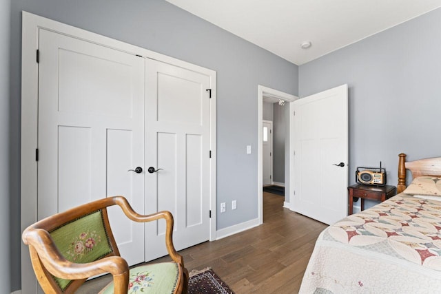 bedroom featuring dark wood-type flooring and a closet