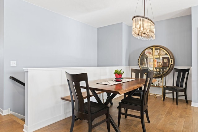 dining room with a notable chandelier and hardwood / wood-style flooring