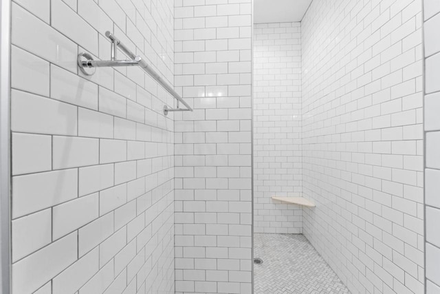 bathroom with tiled shower