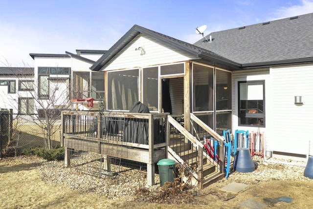 back of property with a sunroom