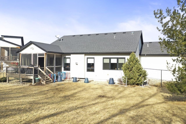 back of house with a yard and a sunroom