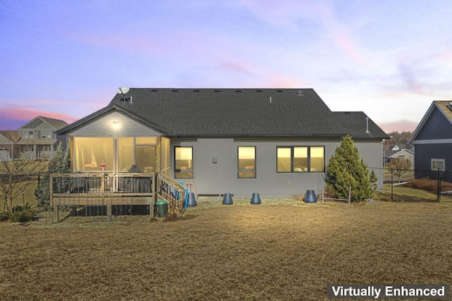 back house at dusk with a wooden deck