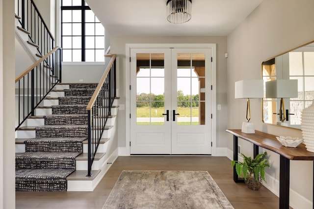 foyer featuring a healthy amount of sunlight, dark hardwood / wood-style floors, and french doors