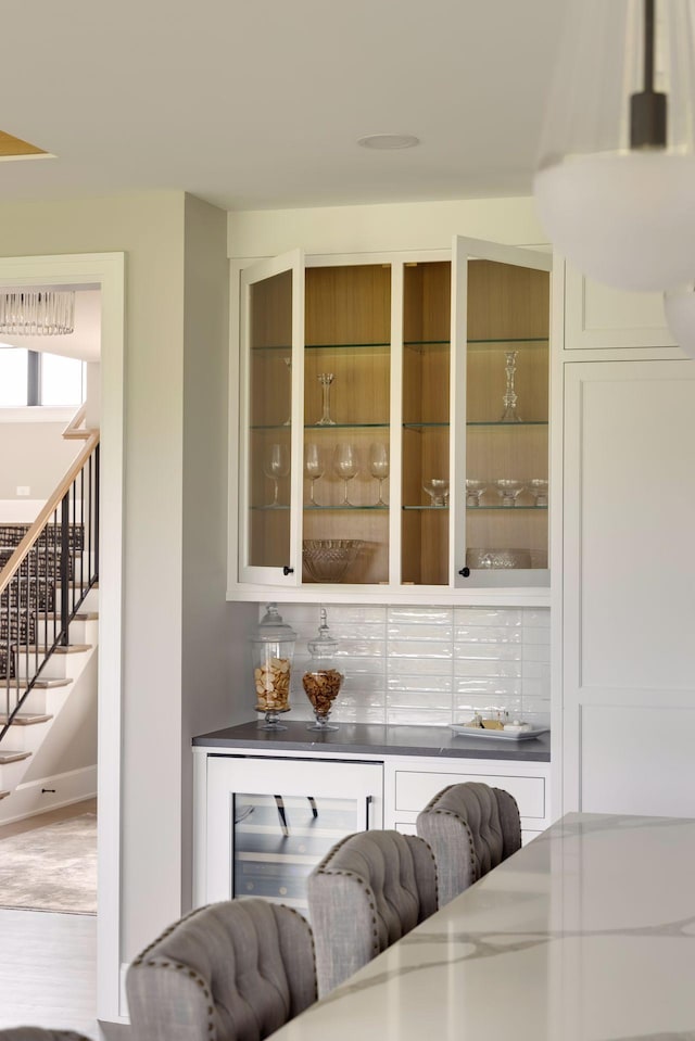 bar featuring white cabinets