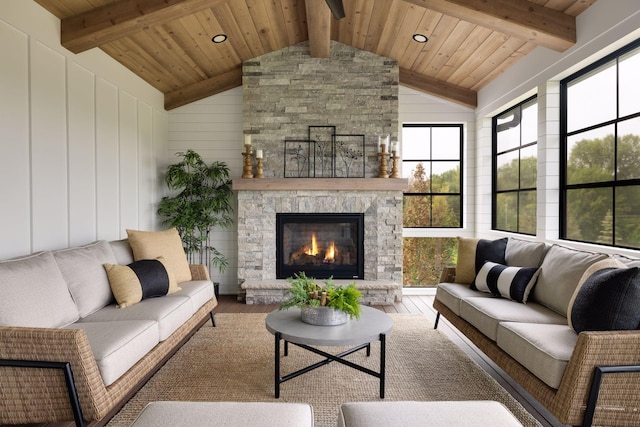 living room with lofted ceiling with beams, a healthy amount of sunlight, and hardwood / wood-style floors