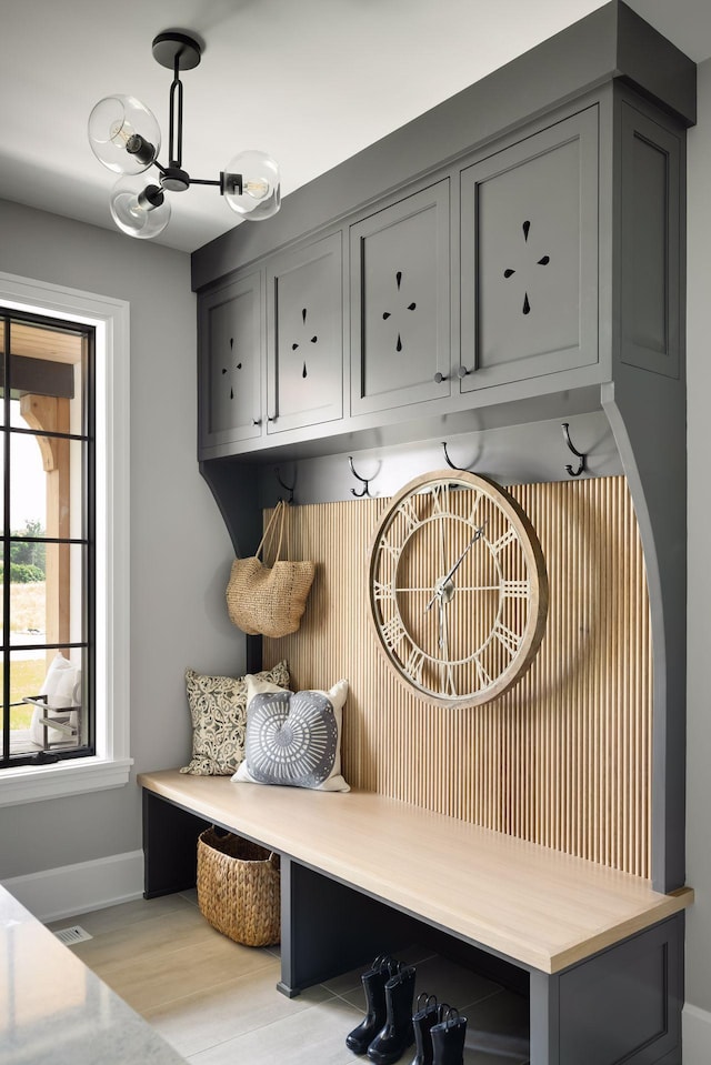 mudroom featuring light hardwood / wood-style floors and a chandelier