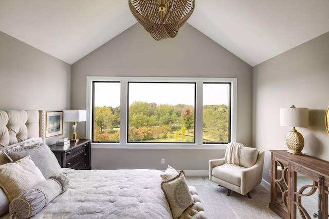 bedroom with carpet flooring, vaulted ceiling, and multiple windows