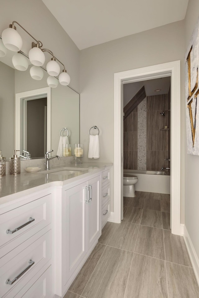 bathroom with tiled shower / bath and vanity