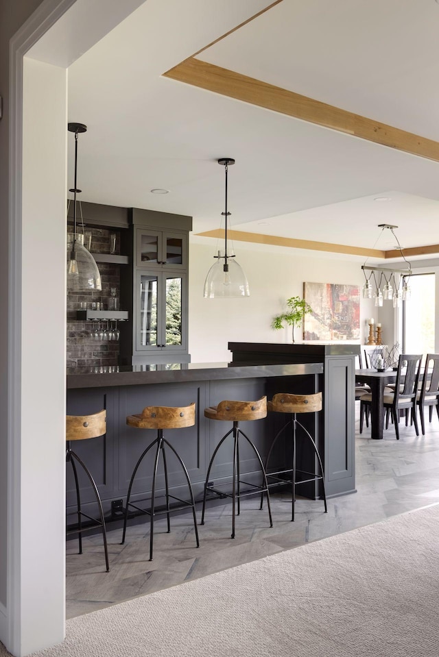 bar featuring pendant lighting and light carpet