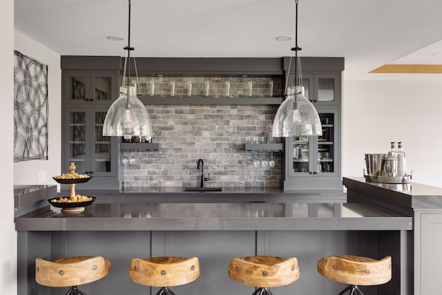 bar with sink and pendant lighting