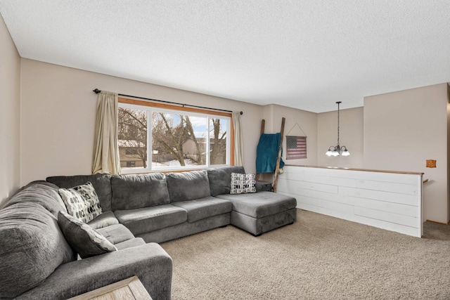 living room featuring an inviting chandelier, a textured ceiling, and carpet flooring