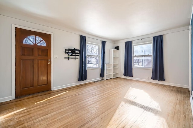 foyer with a wealth of natural light and wood-type flooring