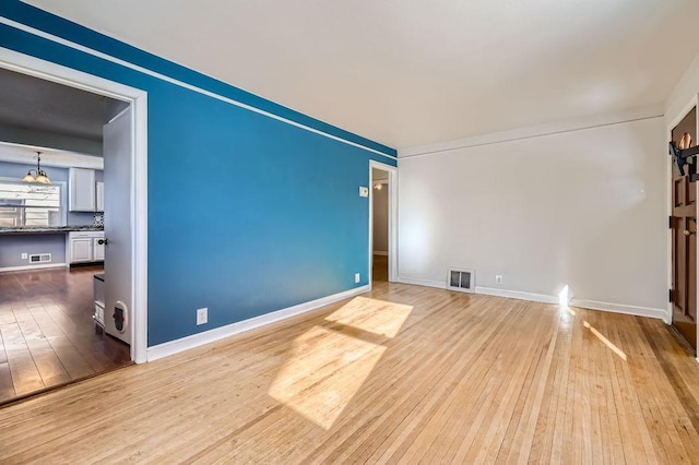 unfurnished room with light hardwood / wood-style floors