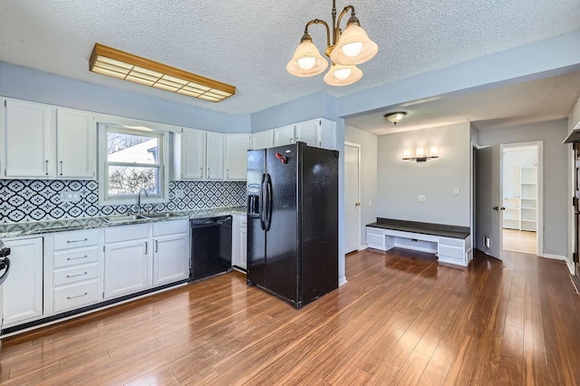 kitchen with white cabinetry, sink, and black appliances