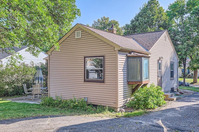 view of property exterior with a patio area