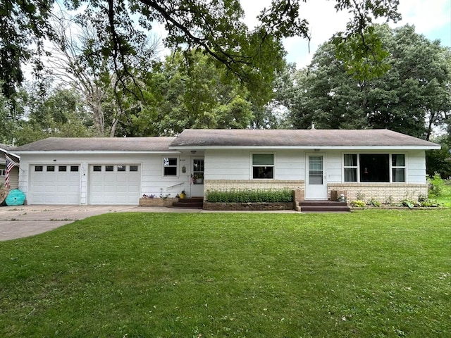 single story home with a garage and a front lawn