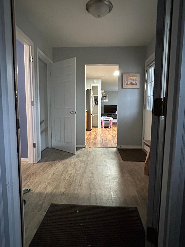 corridor featuring wood-type flooring