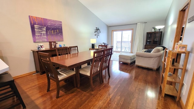 dining space featuring lofted ceiling and dark hardwood / wood-style flooring