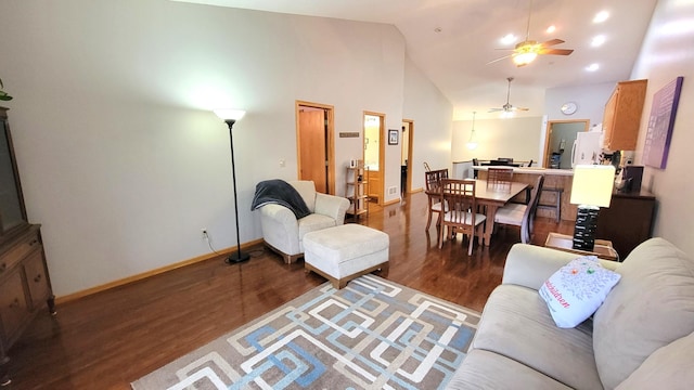 living room featuring ceiling fan, dark hardwood / wood-style flooring, and high vaulted ceiling