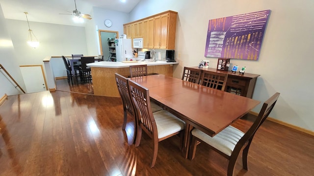 dining space featuring lofted ceiling, dark wood-type flooring, and ceiling fan