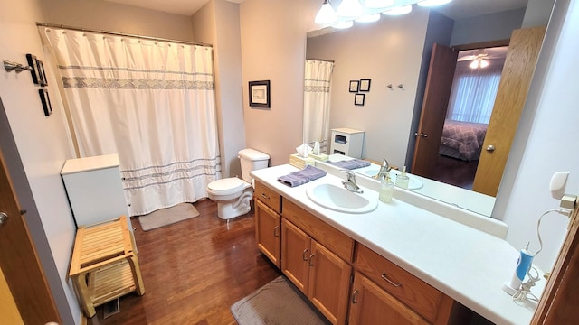 bathroom with hardwood / wood-style flooring, vanity, and toilet