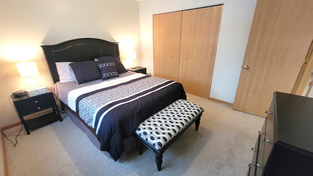 bedroom with light colored carpet and a closet