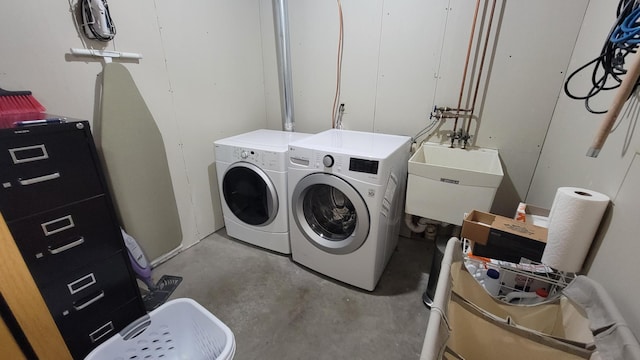 laundry room featuring washing machine and clothes dryer and sink