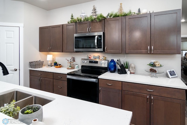 kitchen featuring sink, dark brown cabinets, and stainless steel appliances