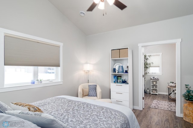 bedroom with ceiling fan, lofted ceiling, and dark hardwood / wood-style floors